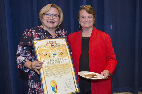 Executive Director Sarah Orth receives the commendation from Supervisor Keuhl