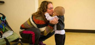 Woman giving a child a kiss