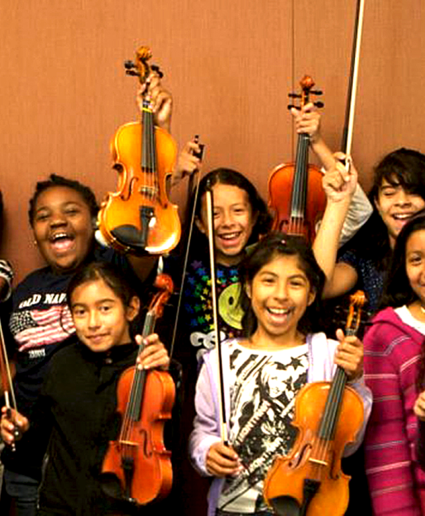 Young violin players showing their violins