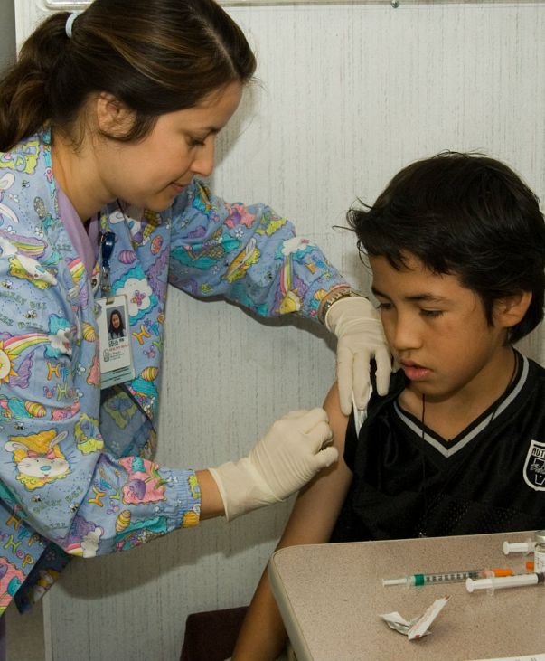 Nurse giving immunization Shot to Child 