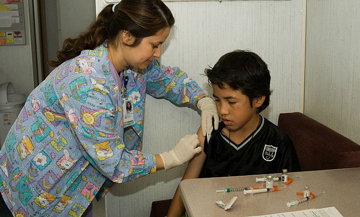 Nurse giving immunization Shot to Child